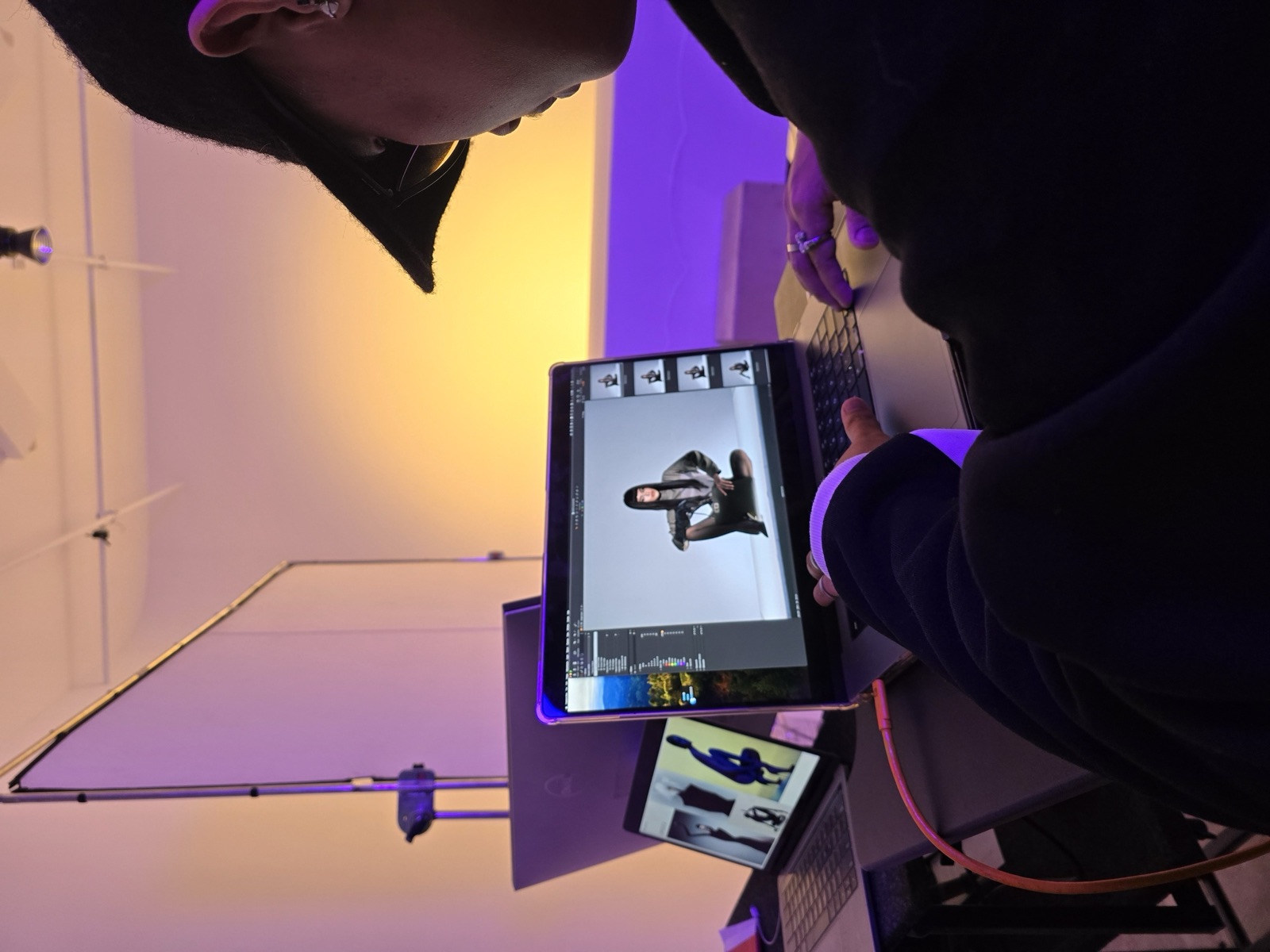 Tethered shooting, editor reviews frames on set
